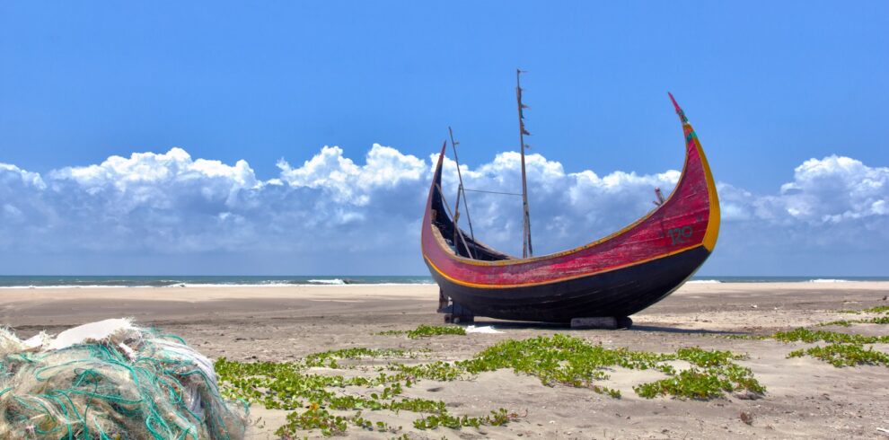 brown boat on white sand during daytime