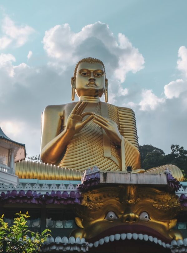 gold buddha statue under cloudy sky during daytime