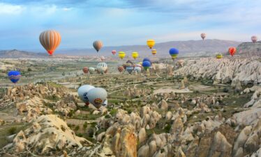 photo of assorted-color air balloon lot in mid air during daytime