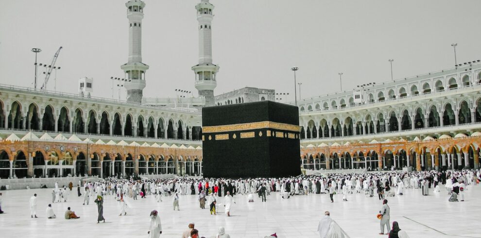 a group of people standing around a large building