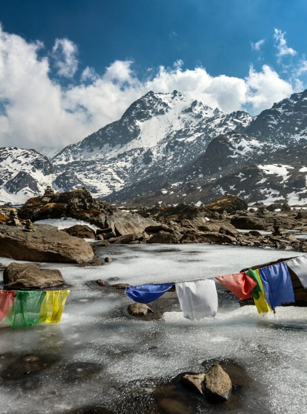 assorted-color of apparel hanged below creek across glacier mountain