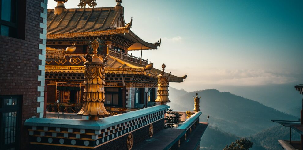 brown and green temple on top of mountain during daytime