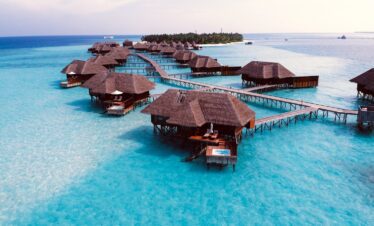 brown wooden cottage on blue body of water during daytime