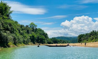 people riding on boat on river during daytime