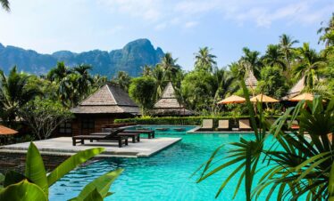 photo of brown bench near swimming pool