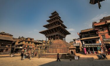 a very tall building sitting in the middle of a town