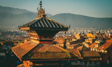 a view of a city with mountains in the background