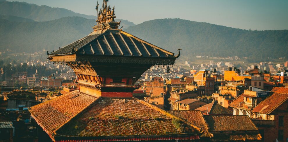 a view of a city with mountains in the background