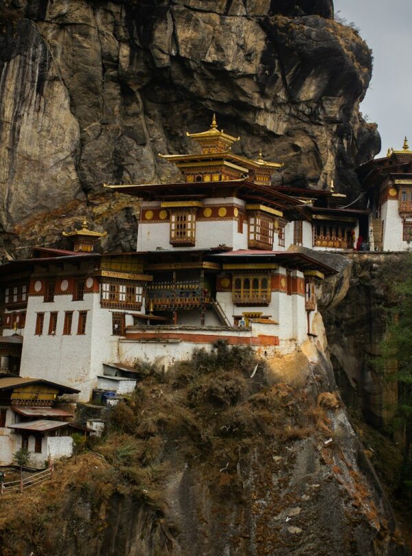 white and brown concrete house on rocky mountain during daytime