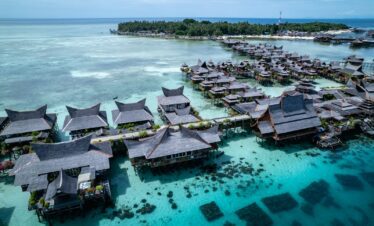 an aerial view of a resort in the ocean