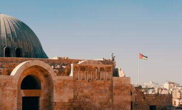 an old building with a flag on top of it